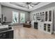 Spacious home office with natural light, built-in shelving, and a wine refrigerator at 932 Mangrove Edge Ct, Bradenton, FL 34208