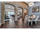 Open-concept living space with stone accents, tile flooring, and view to other living spaces at 932 Mangrove Edge Ct, Bradenton, FL 34208