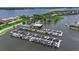 Aerial view of community marina with boat slips, boat house, and waterfront in a Florida neighborhood at 932 Mangrove Edge Ct, Bradenton, FL 34208