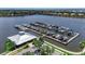 Aerial view of community marina with boat slips and lush landscaping in a Florida neighborhood at 932 Mangrove Edge Ct, Bradenton, FL 34208