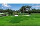 Scenic community park with lush lawn, shady benches, and walking paths for residents at 932 Mangrove Edge Ct, Bradenton, FL 34208