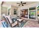 Covered patio boasts comfortable seating, a ceiling fan, and a seamless transition to the home's interior at 932 Mangrove Edge Ct, Bradenton, FL 34208