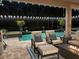 Relaxing outdoor patio with a screened pool, lounge furniture, and a cozy fire pit, perfect for evening entertainment at 932 Mangrove Edge Ct, Bradenton, FL 34208