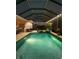Beautiful screened-in pool area with ambient lighting creating a relaxing nighttime atmosphere at 932 Mangrove Edge Ct, Bradenton, FL 34208