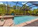 Relaxing screened-in pool area with a spa and lush landscaping offering privacy and tranquility at 932 Mangrove Edge Ct, Bradenton, FL 34208
