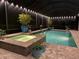 Screened-in pool and spa offer a serene nighttime retreat with lush landscaping and soft lighting at 932 Mangrove Edge Ct, Bradenton, FL 34208