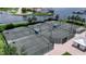 Close up aerial view of community tennis courts with shade pavilions in a Florida neighborhood at 932 Mangrove Edge Ct, Bradenton, FL 34208