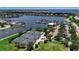 Aerial view of community tennis courts, lush landscaping, and marina with water views in a Florida neighborhood at 932 Mangrove Edge Ct, Bradenton, FL 34208