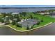 Aerial view of community tennis courts and waterfront in a Florida neighborhood at 932 Mangrove Edge Ct, Bradenton, FL 34208