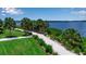 Picturesque community walking path by the water, surrounded by lush greenery and beautiful landscaping at 932 Mangrove Edge Ct, Bradenton, FL 34208