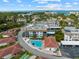 Aerial shot of condos with a pool and recreation area within a lush, tropical community near the beach at 110 Vista Hermosa Cir # 302B, Sarasota, FL 34242
