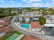 Community aerial showcasing a pool, clubhouse, shuffleboard, and proximity to beach at 110 Vista Hermosa Cir # 302B, Sarasota, FL 34242