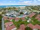 Stunning aerial view of a coastal community with lush landscaping, a pool, shuffleboard and beach access at 110 Vista Hermosa Cir # 302B, Sarasota, FL 34242