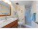 Fresh bathroom featuring updated vanity, a marble countertop, a toilet, and a shower with glass doors at 110 Vista Hermosa Cir # 302B, Sarasota, FL 34242