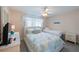 Cozy bedroom showcases two beds, neutral decor, a window, and a ceiling fan at 110 Vista Hermosa Cir # 302B, Sarasota, FL 34242