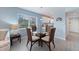 Well lit dining area with large windows and view of kitchen at 110 Vista Hermosa Cir # 302B, Sarasota, FL 34242