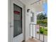 Condo entrance with white door, porch and an exterior view at 110 Vista Hermosa Cir # 302B, Sarasota, FL 34242