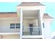 Close-up view of an exterior condo unit with a balcony, showing the building's facade at 110 Vista Hermosa Cir # 302B, Sarasota, FL 34242