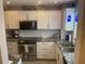 Bright kitchen featuring stainless appliances, white cabinets, granite counters and subway tile backsplash at 110 Vista Hermosa Cir # 302B, Sarasota, FL 34242