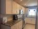 Bright kitchen featuring stainless appliances, white cabinets, granite counters and subway tile backsplash at 110 Vista Hermosa Cir # 302B, Sarasota, FL 34242