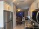 Kitchen flowing into a dining area with stainless steel appliances, granite counters, and white cabinets at 110 Vista Hermosa Cir # 302B, Sarasota, FL 34242