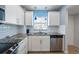 Updated kitchen featuring granite countertops, white cabinets, and stainless steel dishwasher at 110 Vista Hermosa Cir # 302B, Sarasota, FL 34242