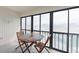 Enclosed lanai showing an outdoor dining table and chairs with a view at 110 Vista Hermosa Cir # 302B, Sarasota, FL 34242