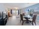 Bright living room with modern tile floors, comfortable seating, and a view of the balcony at 110 Vista Hermosa Cir # 302B, Sarasota, FL 34242
