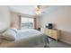 Bright bedroom with a ceiling fan, a chest of drawers, a TV, and a window with natural light at 110 Vista Hermosa Cir # 302B, Sarasota, FL 34242