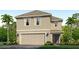 Charming two-story home featuring a symmetrical facade, a two-car garage, and lush landscaping at 12047 Lansing Gln, Parrish, FL 34219