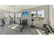 Community gym featuring exercise equipment, weights, and bright windows overlooking the neighborhood at 12047 Lansing Gln, Parrish, FL 34219