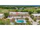 Aerial view showcasing the property, surrounded by lush landscaping, a pool, and a golf course at 1216 Rio De Janeiro Ave # 306, Punta Gorda, FL 33983
