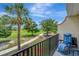 Balcony overlooking a lush green landscape, a golf course, mature trees, and a walking path at 1216 Rio De Janeiro Ave # 306, Punta Gorda, FL 33983