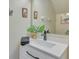 Modern bathroom with white vanity, gray hardware, and decorative art at 1216 Rio De Janeiro Ave # 306, Punta Gorda, FL 33983