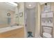 Bright bathroom featuring modern fixtures, a glass enclosed shower, and a decorated shelving unit at 1216 Rio De Janeiro Ave # 306, Punta Gorda, FL 33983