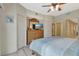 Bedroom featuring a large dresser with mirror, mounted television, and access to additional rooms at 1216 Rio De Janeiro Ave # 306, Punta Gorda, FL 33983