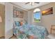 Cozy bedroom features a stylish Murphy bed, a window with a view, and a mounted TV at 1216 Rio De Janeiro Ave # 306, Punta Gorda, FL 33983