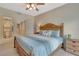 Comfortable bedroom with a ceiling fan, en suite bathroom, walk in closet and attractive wooden headboard and side table at 1216 Rio De Janeiro Ave # 306, Punta Gorda, FL 33983