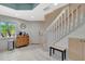 Bright entryway with white walls, tile flooring, coat rack, and staircase at 1216 Rio De Janeiro Ave # 306, Punta Gorda, FL 33983