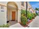 Exterior view of condo front door with colorful landscaping and decor at 1216 Rio De Janeiro Ave # 306, Punta Gorda, FL 33983