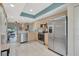 Bright kitchen with stainless steel appliances, light wood cabinets, and tiled floor at 1216 Rio De Janeiro Ave # 306, Punta Gorda, FL 33983