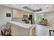 Updated kitchen featuring stainless steel appliances, light wood cabinets, and bar seating at 1216 Rio De Janeiro Ave # 306, Punta Gorda, FL 33983
