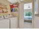 Well-organized laundry room with washer, dryer, storage shelves, and convenient access to bedroom at 1216 Rio De Janeiro Ave # 306, Punta Gorda, FL 33983