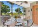 Screened patio with seating, ceiling fan, and views of the golf course at 1216 Rio De Janeiro Ave # 306, Punta Gorda, FL 33983