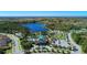 Expansive aerial view of community featuring a large lake, pool and recreational area, lush landscaping, and residential neighborhoods at 12229 Stuart Dr, Venice, FL 34293