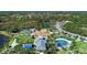 Overhead view of community amenities including a playground, splash pad, and recreation area, all nestled among trees and homes at 12229 Stuart Dr, Venice, FL 34293