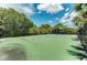 Private fenced-in basketball court with a professionally painted surface at 12229 Stuart Dr, Venice, FL 34293