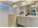 Bathroom with a dual sink vanity, large mirror and glass enclosed shower at 12229 Stuart Dr, Venice, FL 34293