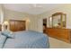 Bedroom with ceiling fan, wooden dresser with mirror and closet at 12229 Stuart Dr, Venice, FL 34293