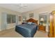 Comfortable bedroom featuring a ceiling fan, two windows and tasteful furniture at 12229 Stuart Dr, Venice, FL 34293